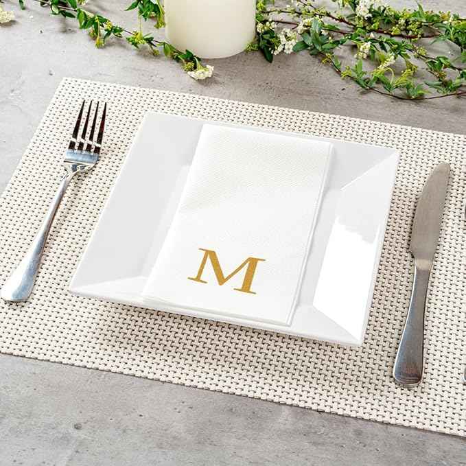 Restaurantware Napkins Pack of 300 Gold Letter M Linen-Feel Paper Disposable Guest Towels 15.75 x 7.87 Inches, Elegant Airlaid White Napkins For Birthdays, Weddings and Catering Events
