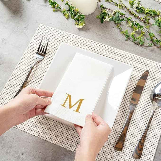 Restaurantware Napkins Pack of 300 Gold Letter M Linen-Feel Paper Disposable Guest Towels 15.75 x 7.87 Inches, Elegant Airlaid White Napkins For Birthdays, Weddings and Catering Events